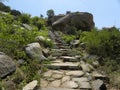 Rocky stone steps which leads to the top of the hill Royalty Free Stock Photo