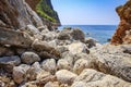 Rocky and stony shore of tropical sea. view of sea through stones of coastline. Mountains and sea. Seascape Royalty Free Stock Photo