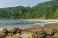 Rocky tropical beach with bay in lagoon in Thailand. Ocean. Trees. Summer. Hills. Stones. Sunny day