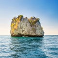 Rocky tropical island in blue sea Royalty Free Stock Photo