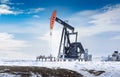 Oil and gas pump jack in motion working on a well site Royalty Free Stock Photo