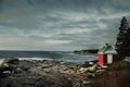 Rocky wild coast of the Atlantic Ocean. USA. Maine. A small lighthouse house on the rocks