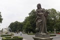 A rococo female sculpture into saxon garden with fountain and tourist