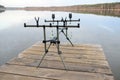 Rod pod with electronic bite alarms on pier by lake