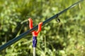 Rod on a rack against a background of a meadow. Royalty Free Stock Photo