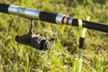 Rod on a rack against a background of a meadow. Royalty Free Stock Photo