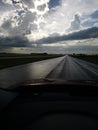 Long highway sun through clouds