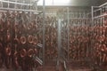 ÃÂ roduction of sausage products. Sausages in the factory storage. Dried sausage hanging on a rope on a metal frame in the smoke Royalty Free Stock Photo