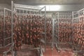 ÃÂ roduction of sausage products. Sausages in the factory storage. Dried sausage hanging on a rope on a metal frame in the smoke Royalty Free Stock Photo