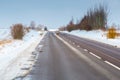 roe deer crossing asphalt road in winter season Royalty Free Stock Photo