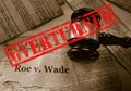 Roe v Wade news headline with gavel and Overturned stamp on the United States Constitution