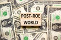 Roe vs Wade post-Roe world symbol. Concept words Post-Roe world on wooden blocks on a beautiful background from dollar bills.