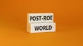 Roe vs Wade post-Roe world symbol. Concept words Post-Roe world on wooden blocks on a beautiful orange table orange background.