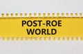 Roe vs Wade post-Roe world symbol. Concept words Post-Roe world on yellow paper on a beautiful white background. Business and Roe