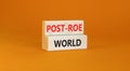 Roe vs Wade post-Roe world symbol. Concept words Post-Roe world on wooden blocks on a beautiful orange table orange background.