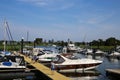 View over yacht pier on inland harbor with boats, city skyline background in summer Royalty Free Stock Photo