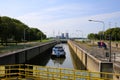 View on lock sluice at river Maas with cargo ship, blurred towers of RWE power station background