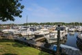 View on inland harbor at river Maas with yachts against blue summer sky