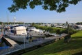 View on inland harbor at river Maas with yachts against blue summer sky