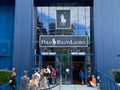 View on blue facade of polo ralph lauren fashion store with queue of people exterior of entrance