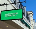 View on facade with green logo lettering of United colors of Benetton fashion company at shop entrance Royalty Free Stock Photo