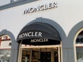 View on facade with logo lettering of Moncler fashion company at shop entrance