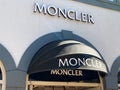 View on facade with logo lettering of Moncler fashion company at shop entrance