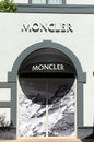 View on facade with logo lettering of Moncler fashion company at shop entrance