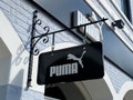 View on facade with logo lettering of Puma sportwear company at shop entrance