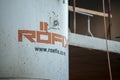 Rofix logo on a concrete mixer in front of a construction site.