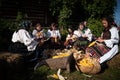 Rogoz, Romania, October 12th, 2019, Women wearing traditional separates corn from chaff - disjoca