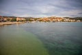 Rogoznica, Croatia - October 12, 2021: Coastline view at marble Rogoznica town scenery with sandy beach in foreground Royalty Free Stock Photo