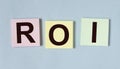 ROI acronym, return of investment word on sticky notes
