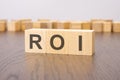 ROI text on wooden blocks. wooden background. foreground