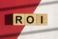 ROI word. Return of investment term. Acronym on cubes