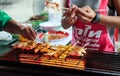 Roiet, Thailand - 20 Feb, 2018 : An unidentified woman grilled BBQ in Chinese Ma La style at Boon Koon Lan Temple fair in