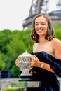 2023 Roland Garros Champion Iga Swiatek of Poland posing with The Suzanne-Lenglen Cup at the Pont de Bir-Hakeim