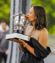 2023 Roland Garros Champion Iga Swiatek of Poland posing with The Suzanne-Lenglen Cup under the Pont de Bir-Hakeim