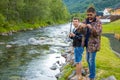 Roldal, Norway - 26.06.2018: Father and son are fishermans fly fishing in river near Rodal town, Norway Royalty Free Stock Photo