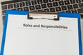 Roles and responsibilities document in the tablet at the laptop on the table. Royalty Free Stock Photo