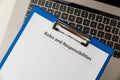 Roles and responsibilities document in the tablet at the laptop on the table. Royalty Free Stock Photo