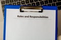 Roles and responsibilities document in the tablet at the laptop on the table.