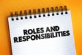 Roles And Responsibilities text quote on notepad, concept background