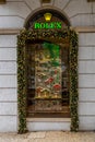 Rolex logo sign, green Rolex letters with gold yellow crown. And with Christmas decoration.