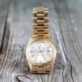 Rolex Oyster Perpetual Day- Date watch on wooden background