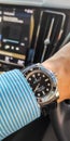 Rolex Submariner no date model on wrist in Volvo car