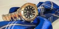 Rolex Yacht master model 126621 with black dial, two tone oyster strap, put on the table with blue neck tie
