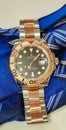 Rolex Yacht master model 126621 with black dial, two tone oyster strap, put on the table with blue neck tie