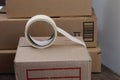 A roll of adhesive tape on a cardboard box