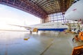 Roll-in of the aircraft from the hangar by a aerodrome tractor, after repair. Royalty Free Stock Photo